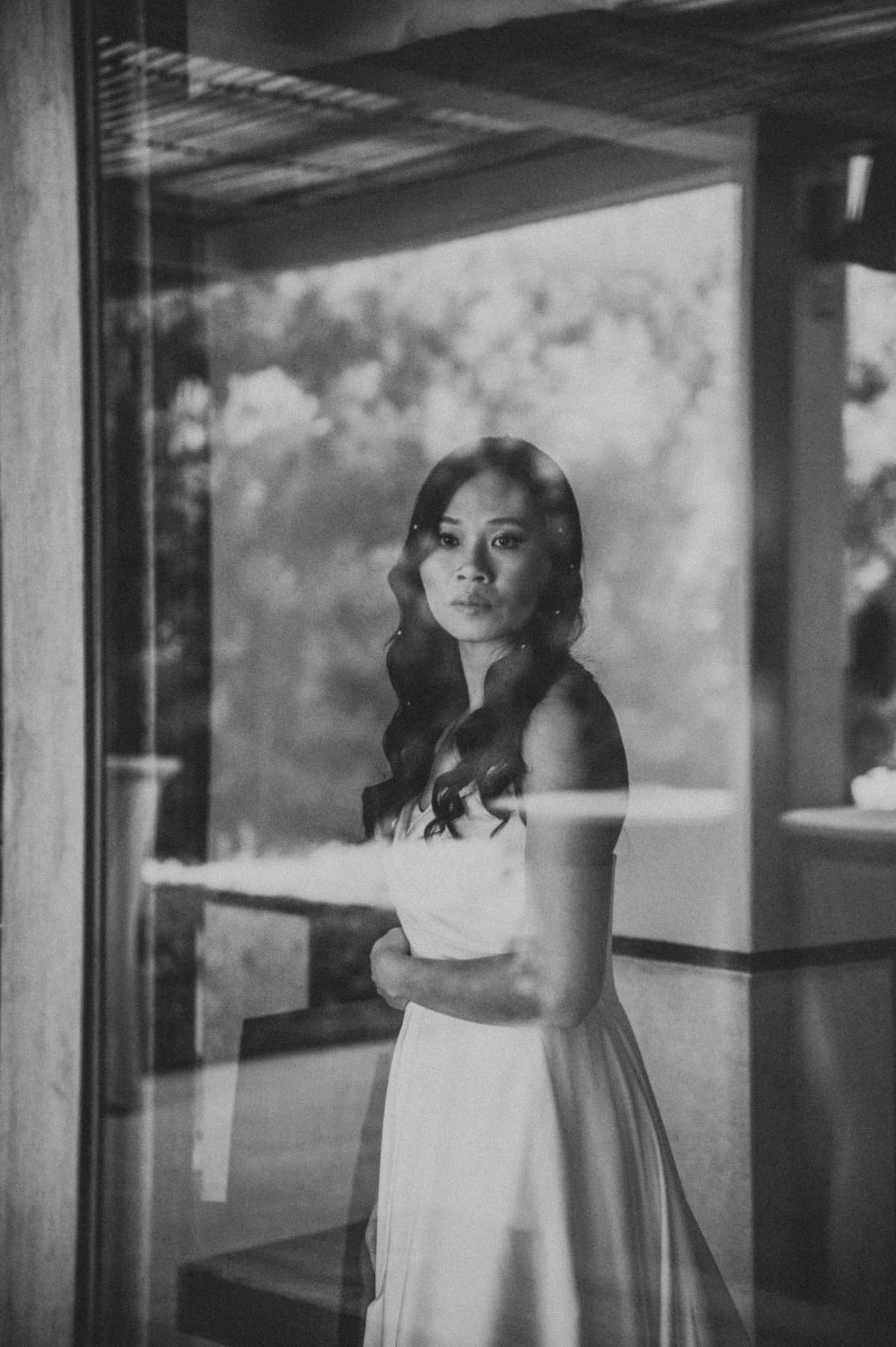 A bride seen quietly through a window
