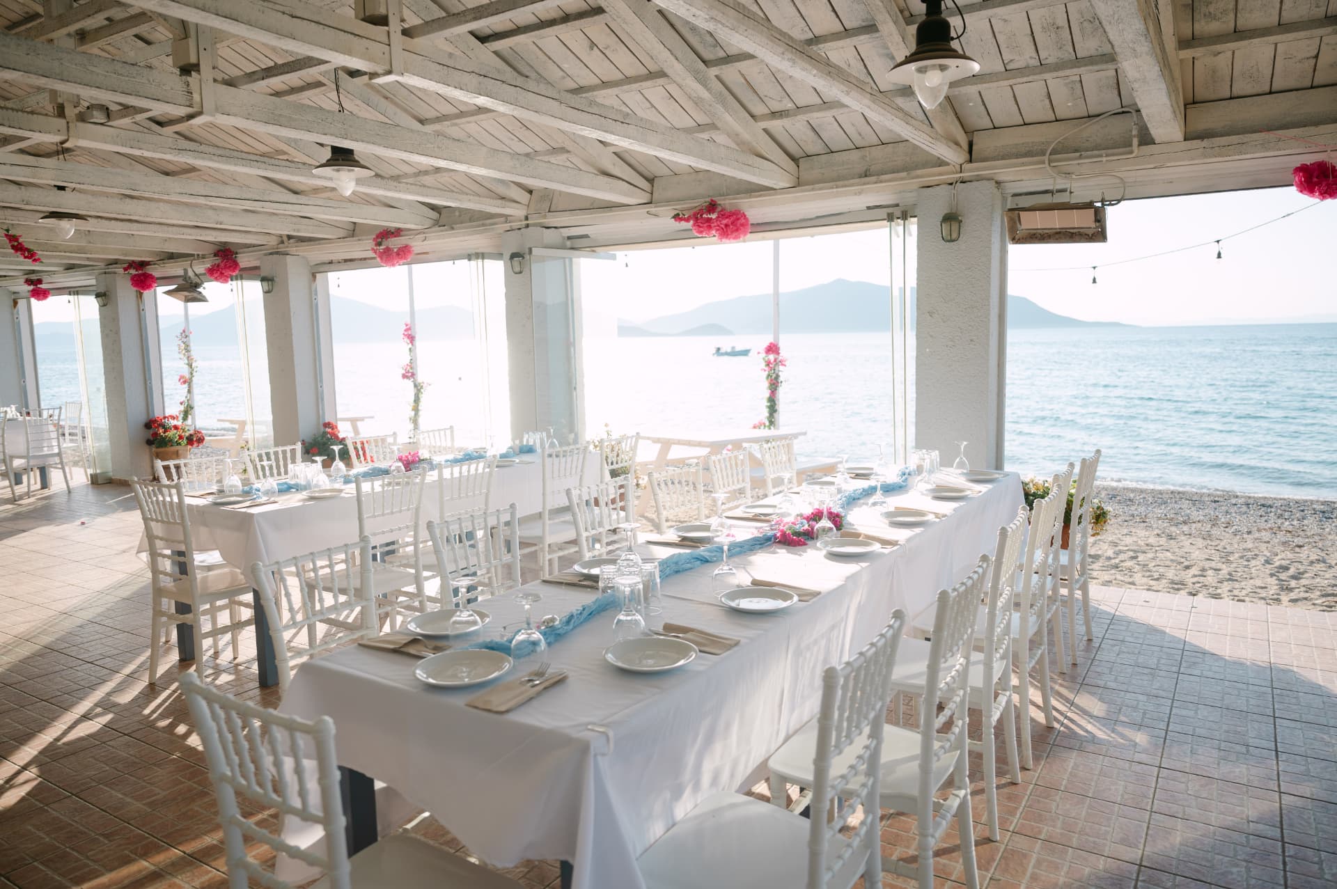 A long wedding table set by the sea in Greece