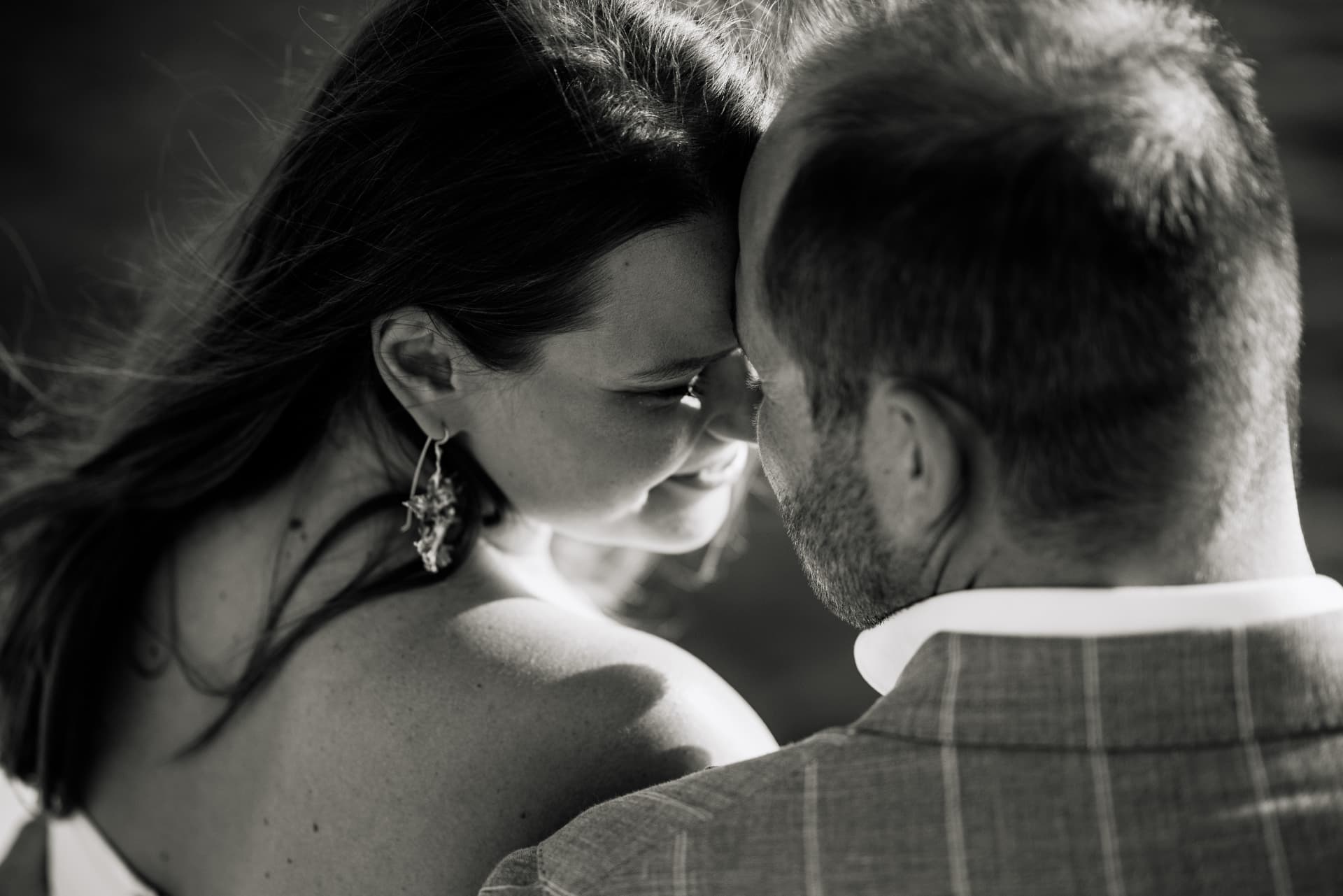 A bride and groom resting their foreheads together