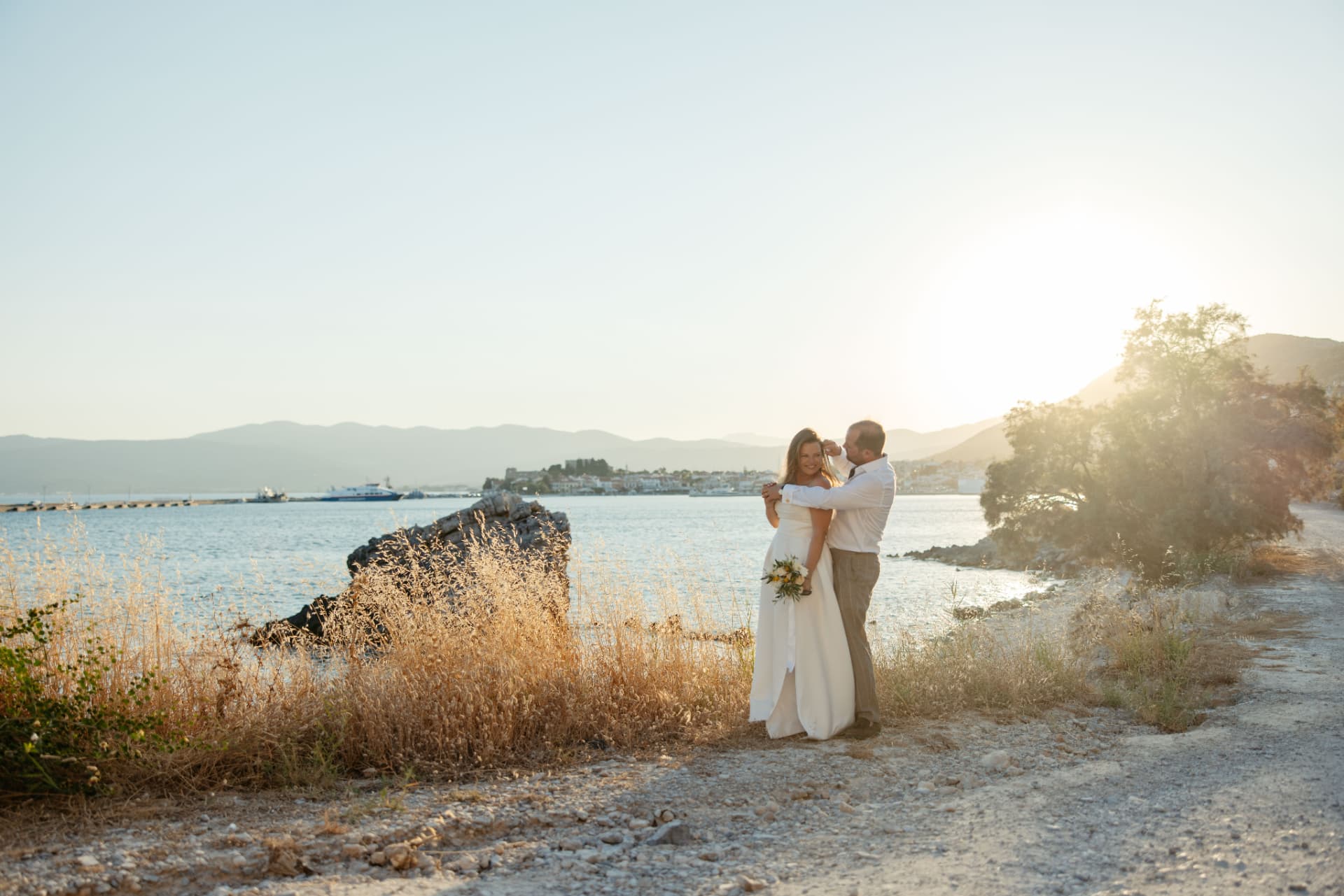 A couple embracing above the bay at sunset