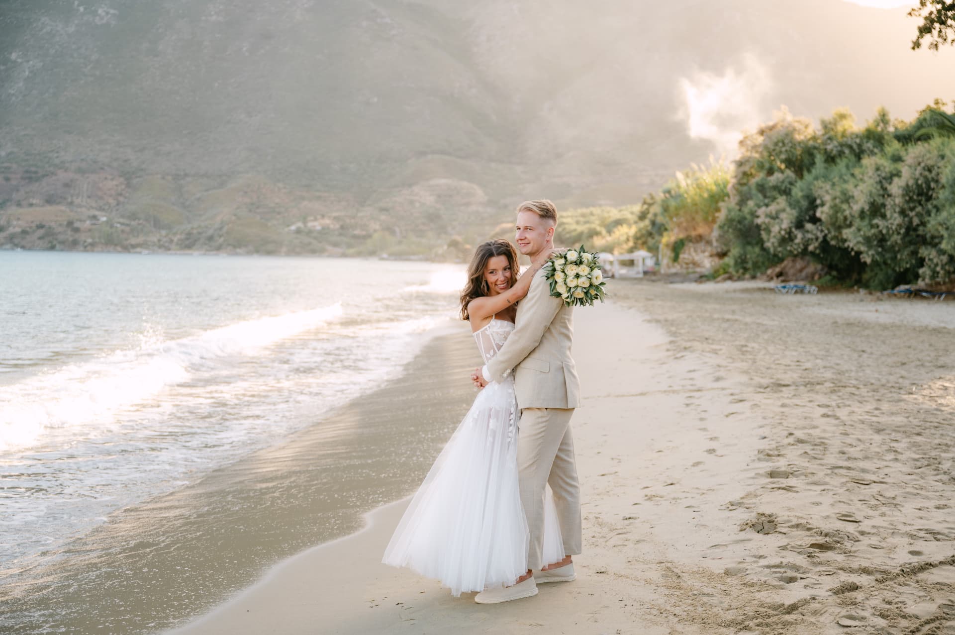 A couple holding each other on the beach